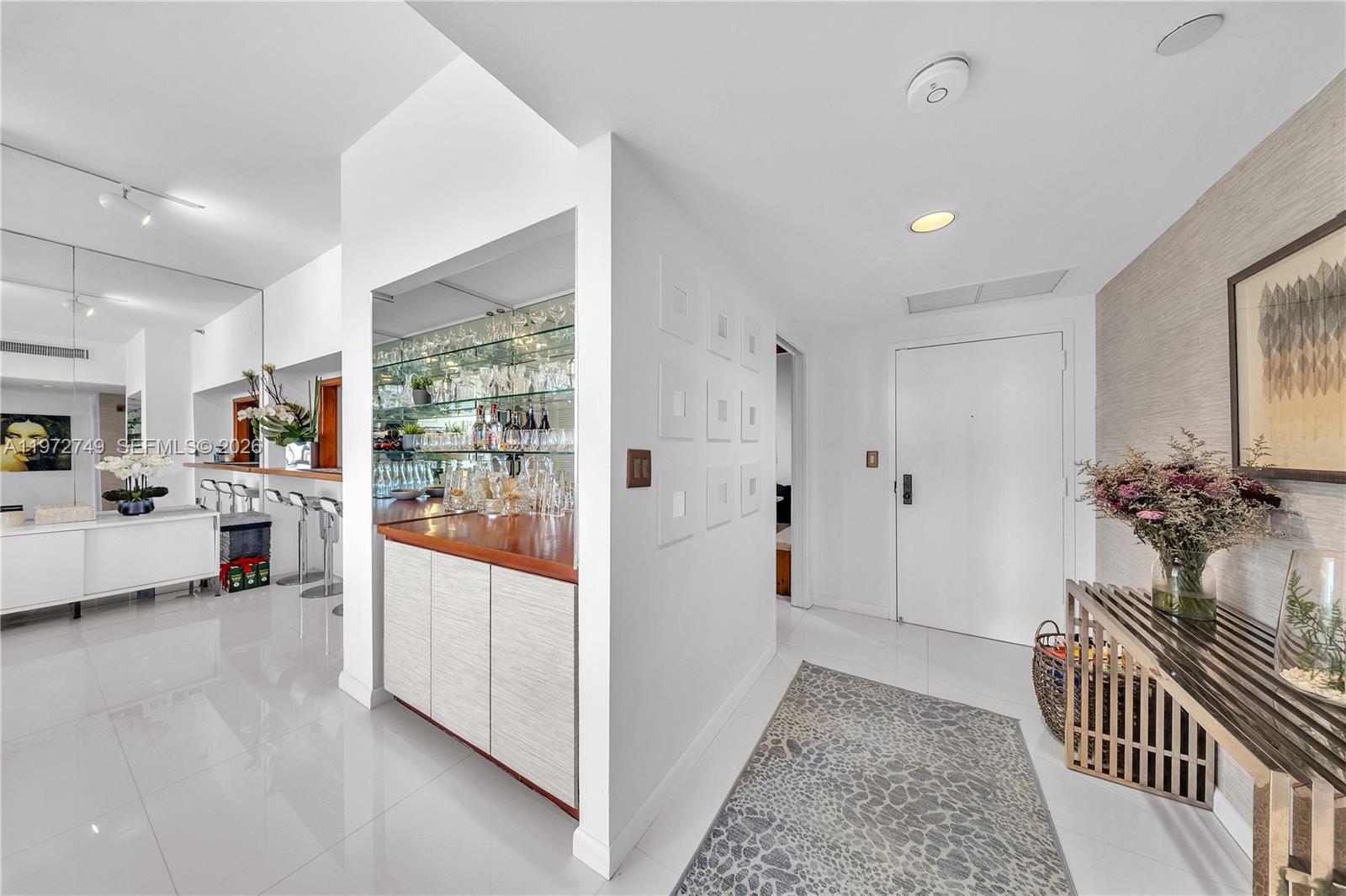 Key Colony Condominiums Key Biscayne, FL 33149 - Photo 10 of 20 a view of a hallway with dining area and chandelier