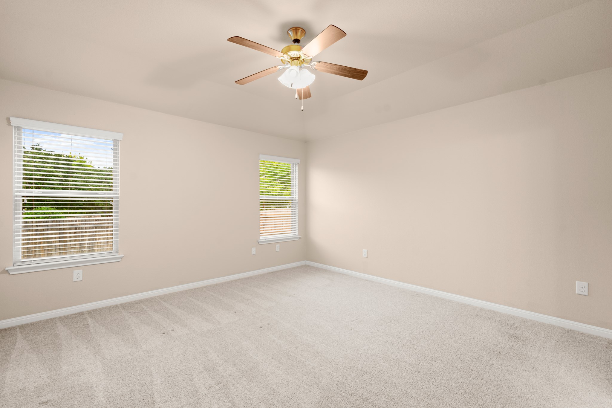 305 Longhorn Cavern Road Leander, TX 78641 - Photo 10 of 21 The primary suite is a peaceful retreat, featuring plenty of room for a king-sized bed and two bright windows looking out to the yard.