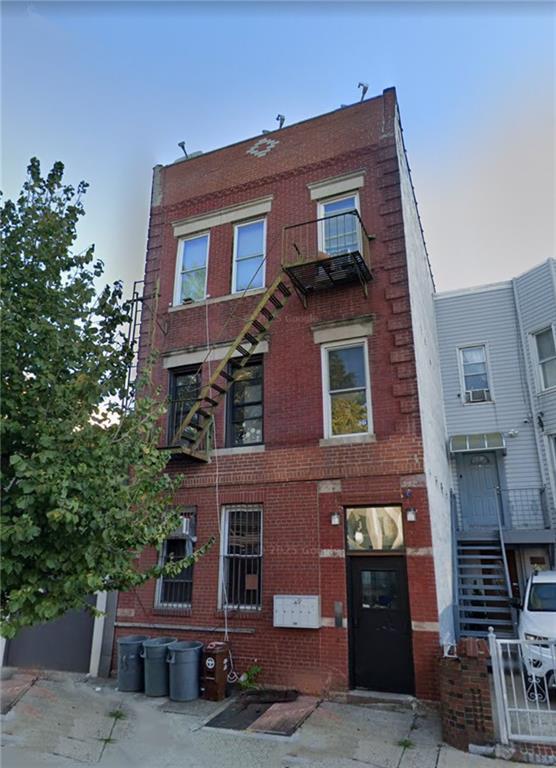 a front view of a building with a garden