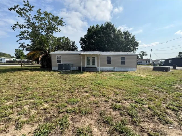 a view of a house with yard and sitting area