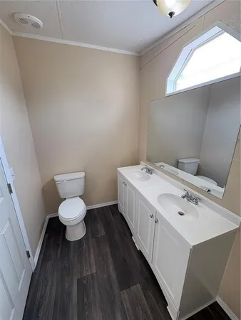 a view of a kitchen with wooden floor and electronic appliances