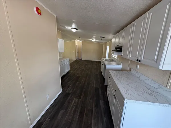 a view of a livingroom with wooden floor and white doors