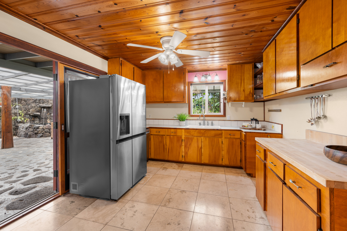 76-6179 Mania Road Kailua-Kona, HI 96740 - Photo 19 of 30 a kitchen with stainless steel appliances granite countertop a refrigerator and a sink