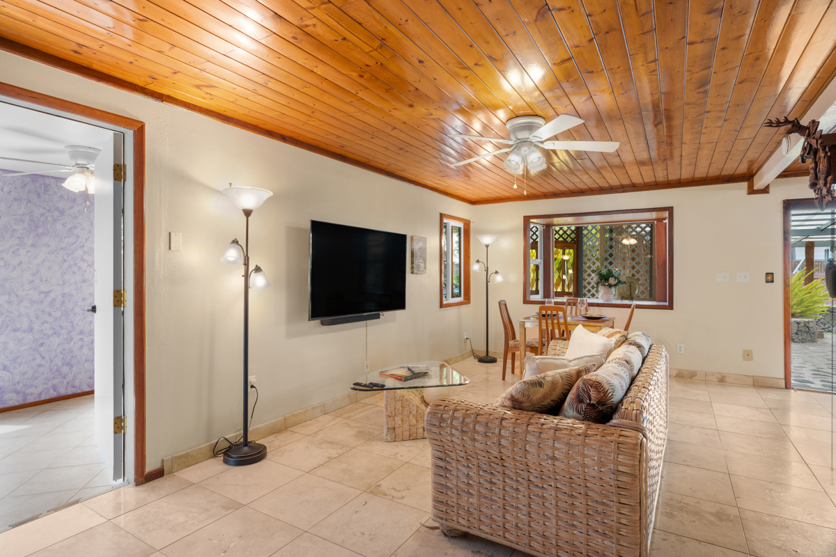 76-6179 Mania Road Kailua-Kona, HI 96740 - Photo 20 of 30 a living room with furniture and a flat screen tv