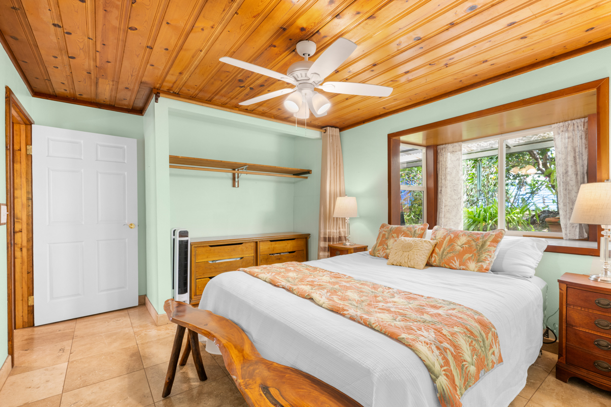 76-6179 Mania Road Kailua-Kona, HI 96740 - Photo 21 of 30 a bedroom with a bed and a chandelier