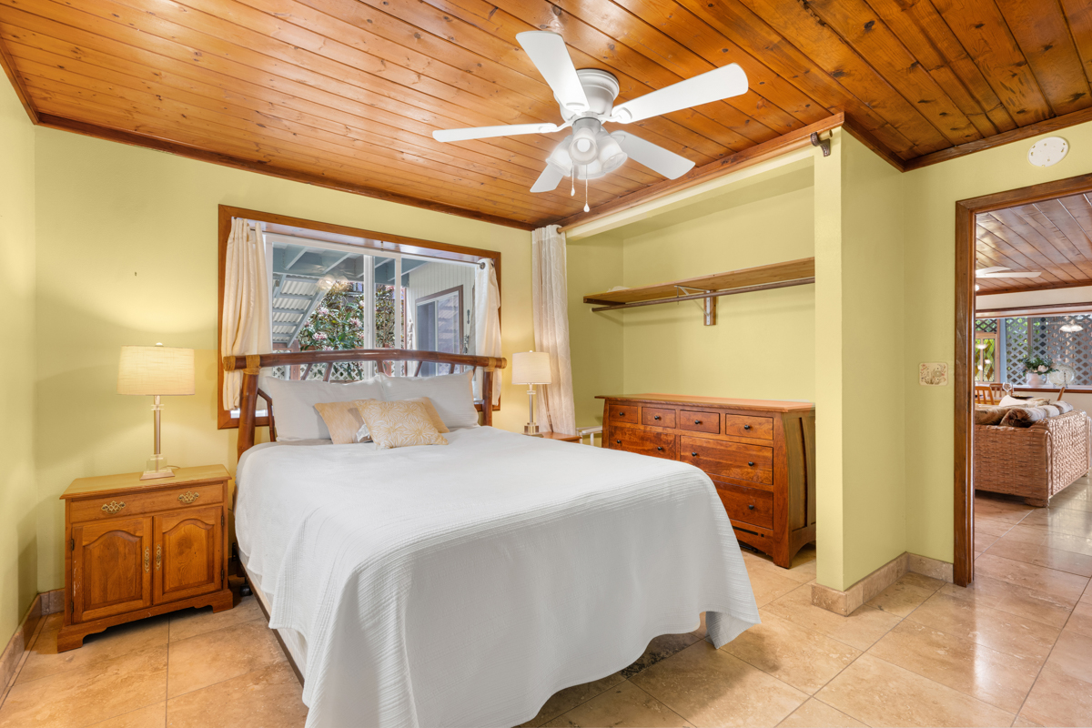 76-6179 Mania Road Kailua-Kona, HI 96740 - Photo 23 of 30 a bedroom with a bed and a view of bathroom