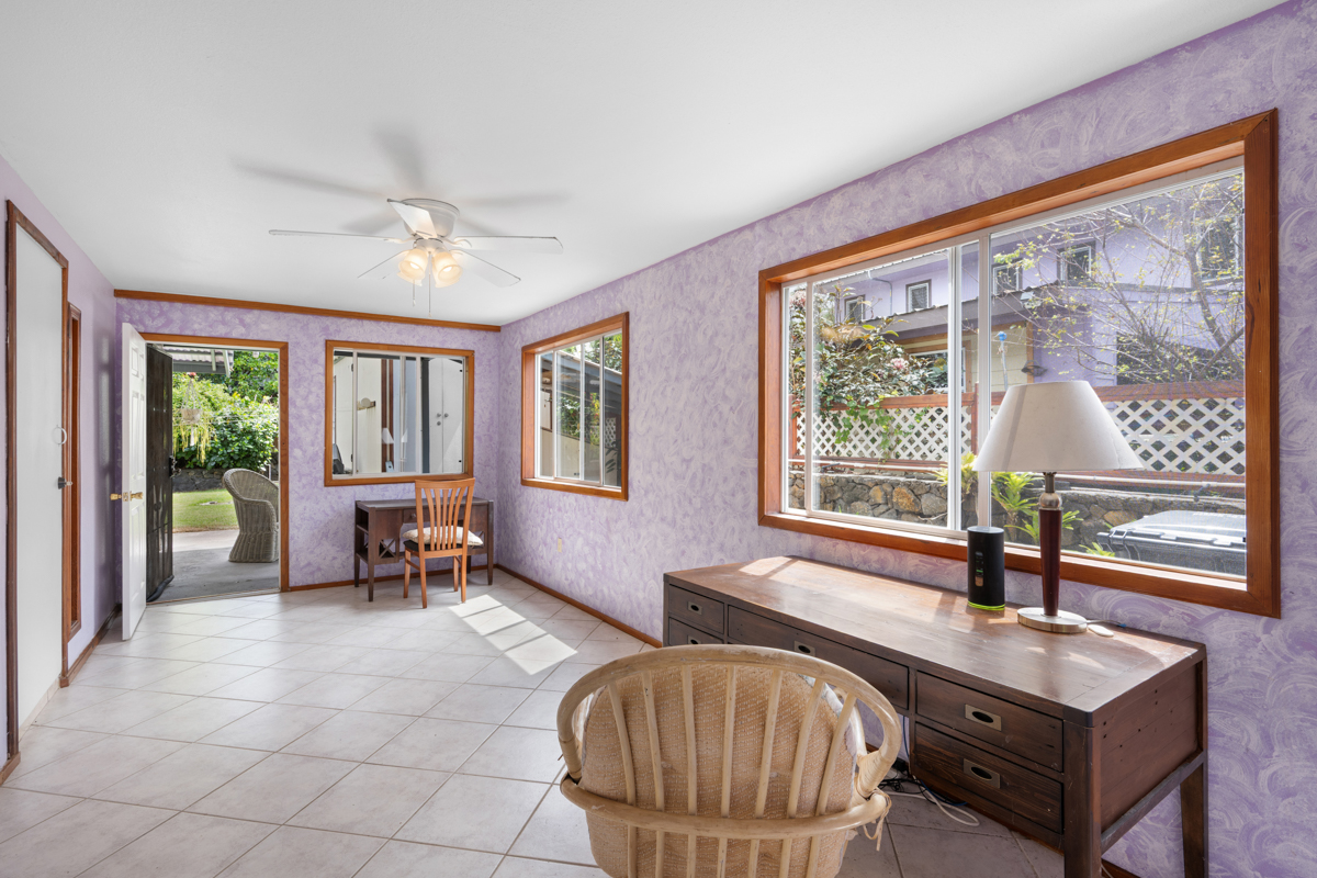 76-6179 Mania Road Kailua-Kona, HI 96740 - Photo 24 of 30 a living room with furniture a table and large windows
