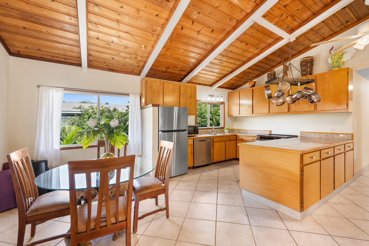 76-6179 Mania Road Kailua-Kona, HI 96740 - Photo 5 of 30 a kitchen with stainless steel appliances granite countertop a stove a sink and a refrigerator
