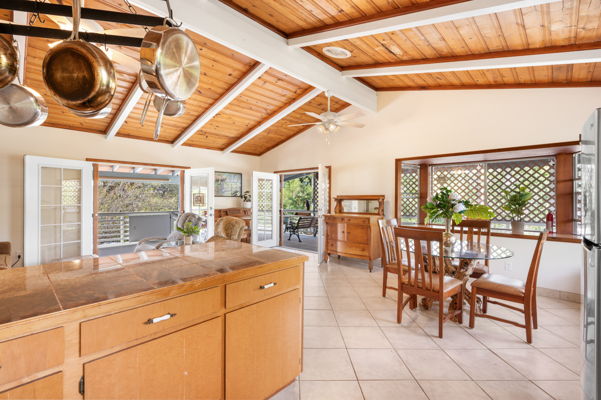 76-6179 Mania Road Kailua-Kona, HI 96740 - Photo 7 of 30 a kitchen with a table and chairs next to a window