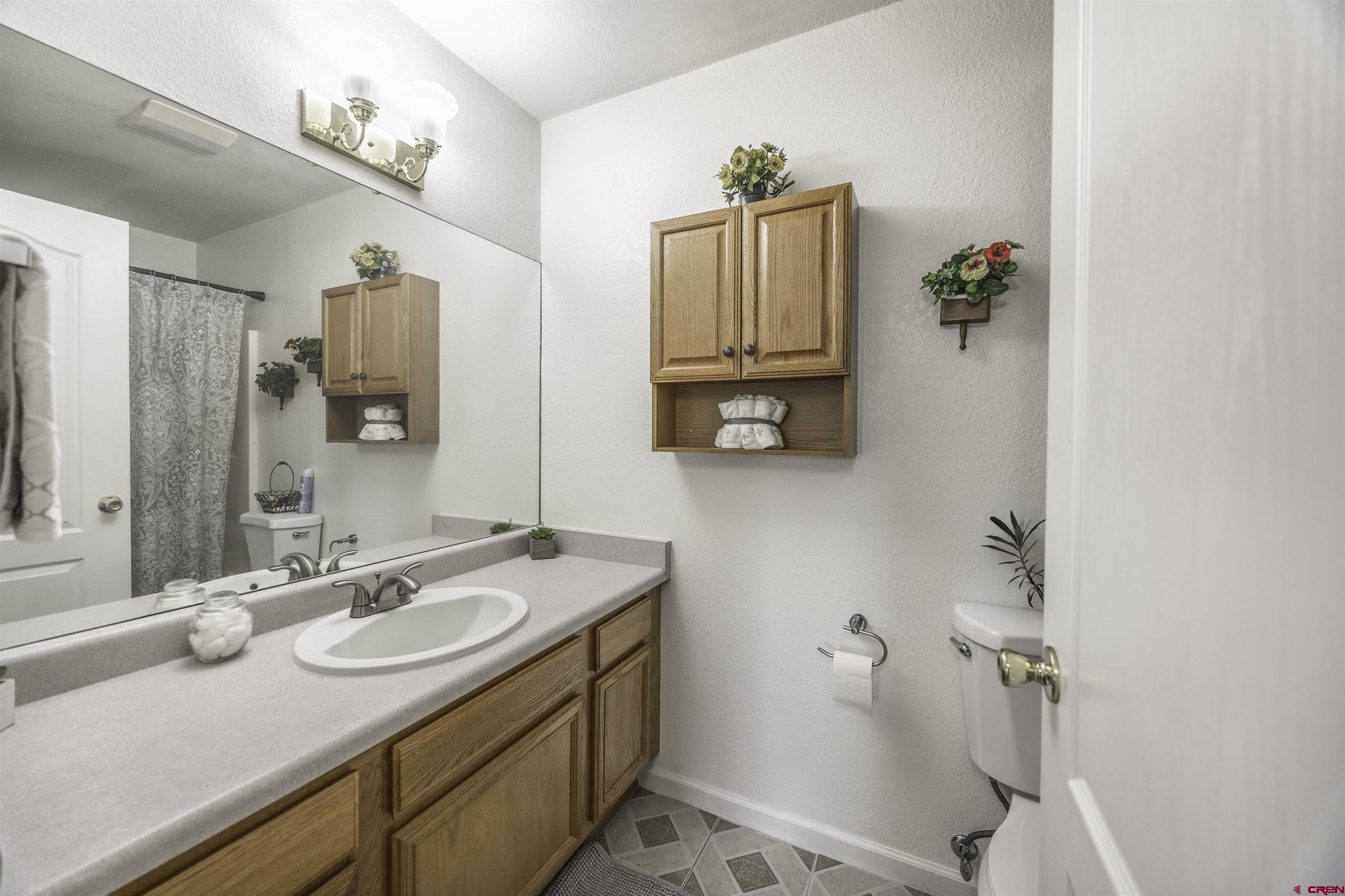 16303 6420th Road Montrose, CO 81403 - Photo 13 of 31 a bathroom with a sink vanity granite and a mirror