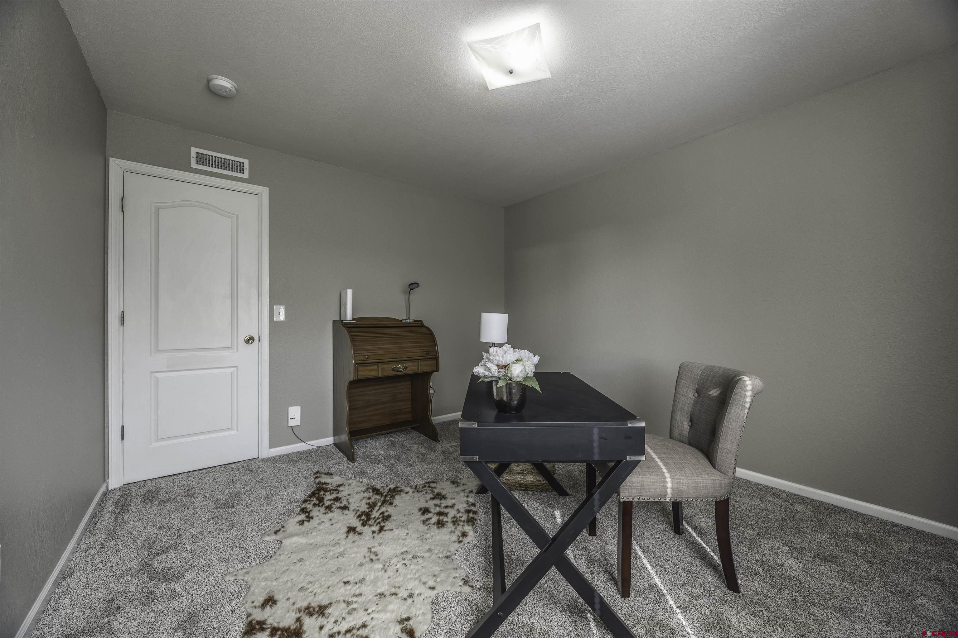 16303 6420th Road Montrose, CO 81403 - Photo 15 of 31 a workspace room with furniture and a rug