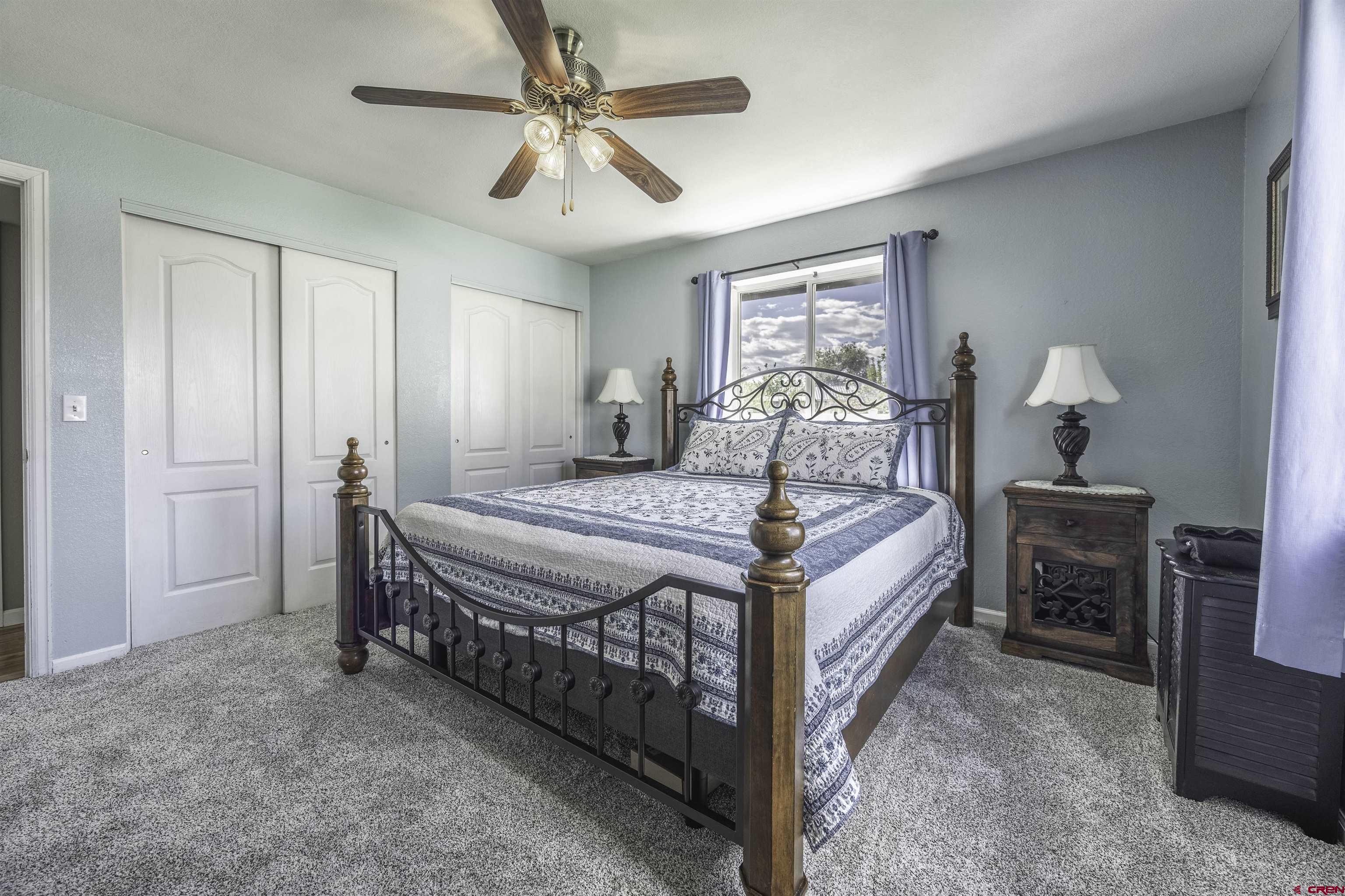 16303 6420th Road Montrose, CO 81403 - Photo 18 of 31 a bedroom with a bed and a chandelier