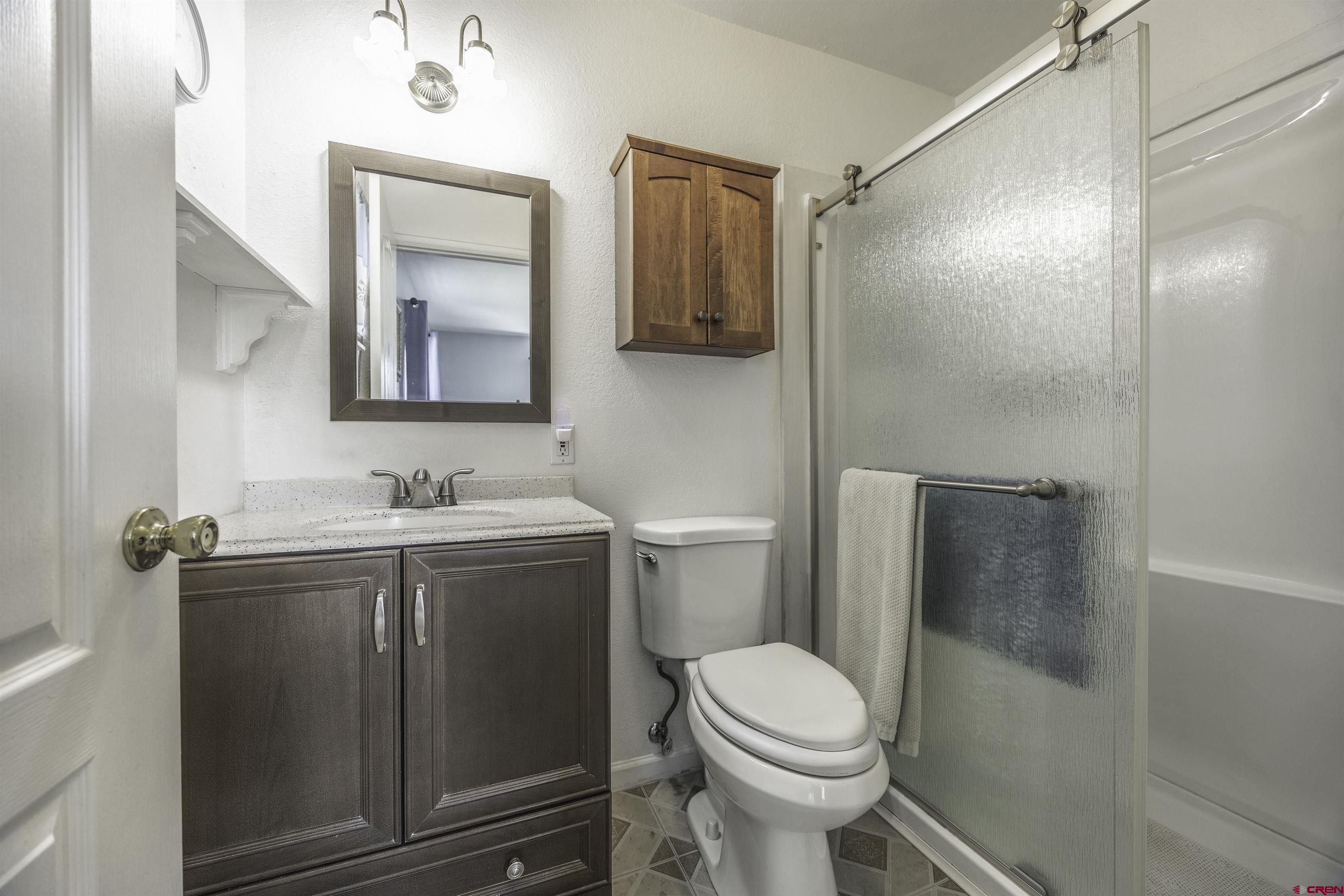 16303 6420th Road Montrose, CO 81403 - Photo 19 of 31 a bathroom with a sink toilet and shower