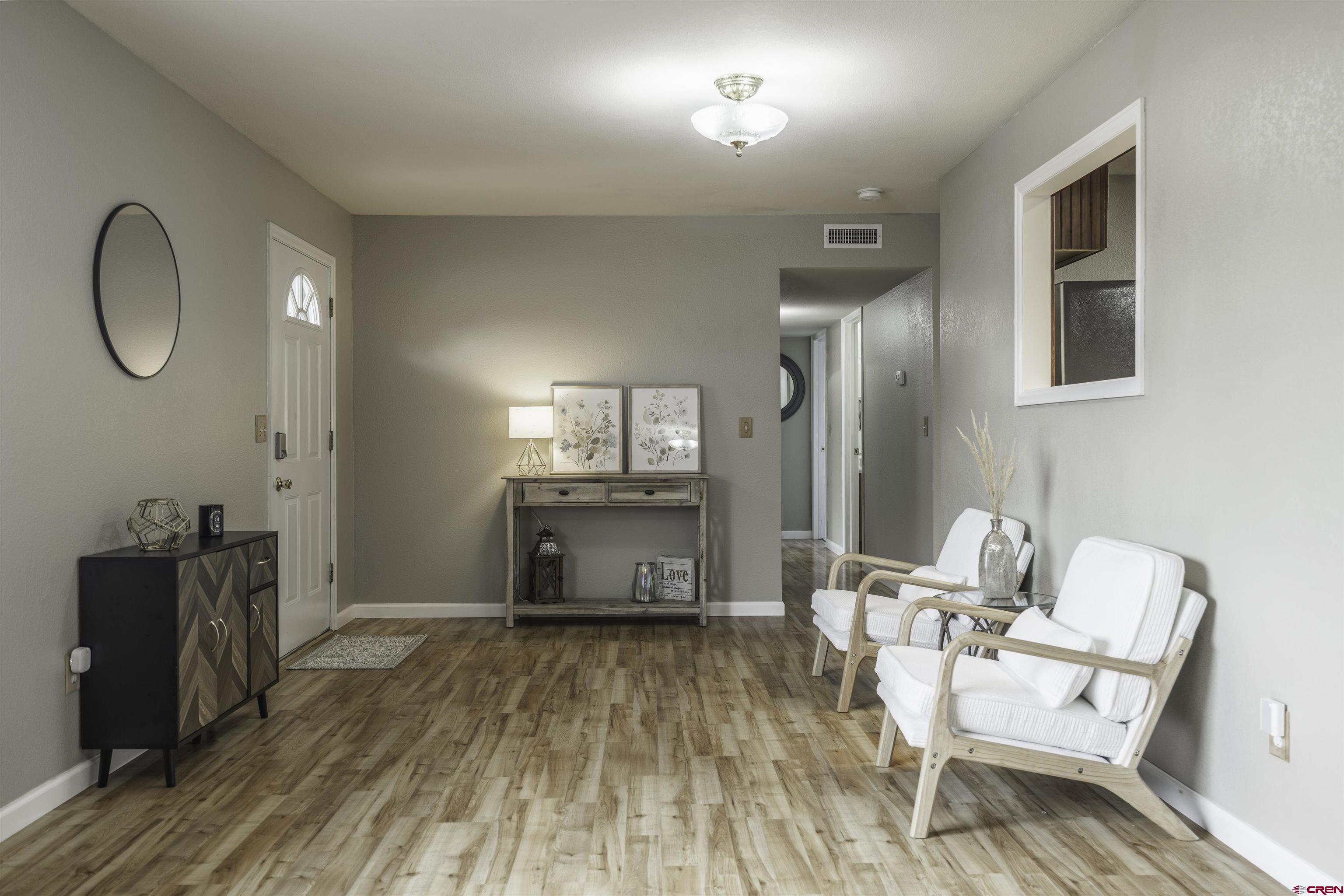 16303 6420th Road Montrose, CO 81403 - Photo 2 of 31 a living room with furniture and a wooden floor