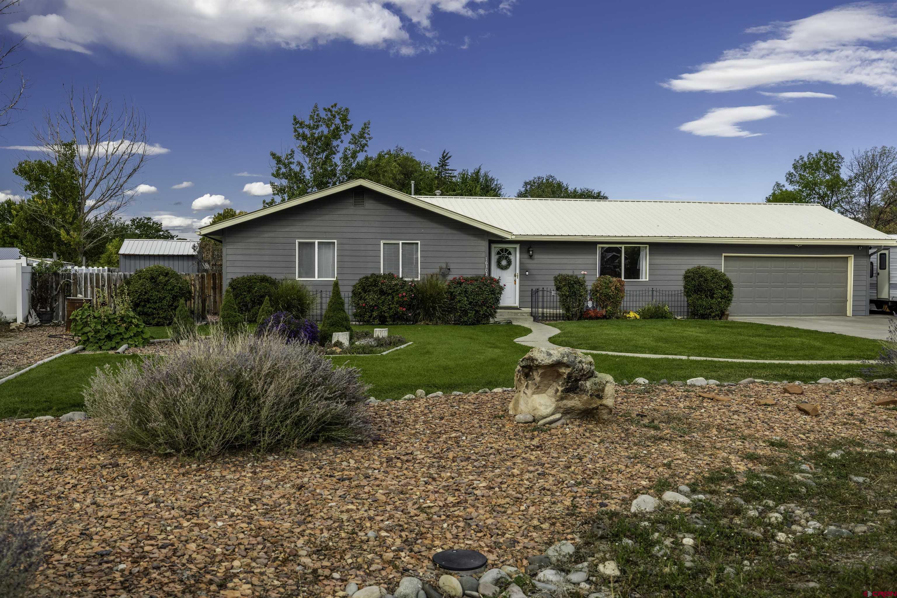 16303 6420th Road Montrose, CO 81403 - Photo 21 of 31 a view of a house with a yard and potted plants