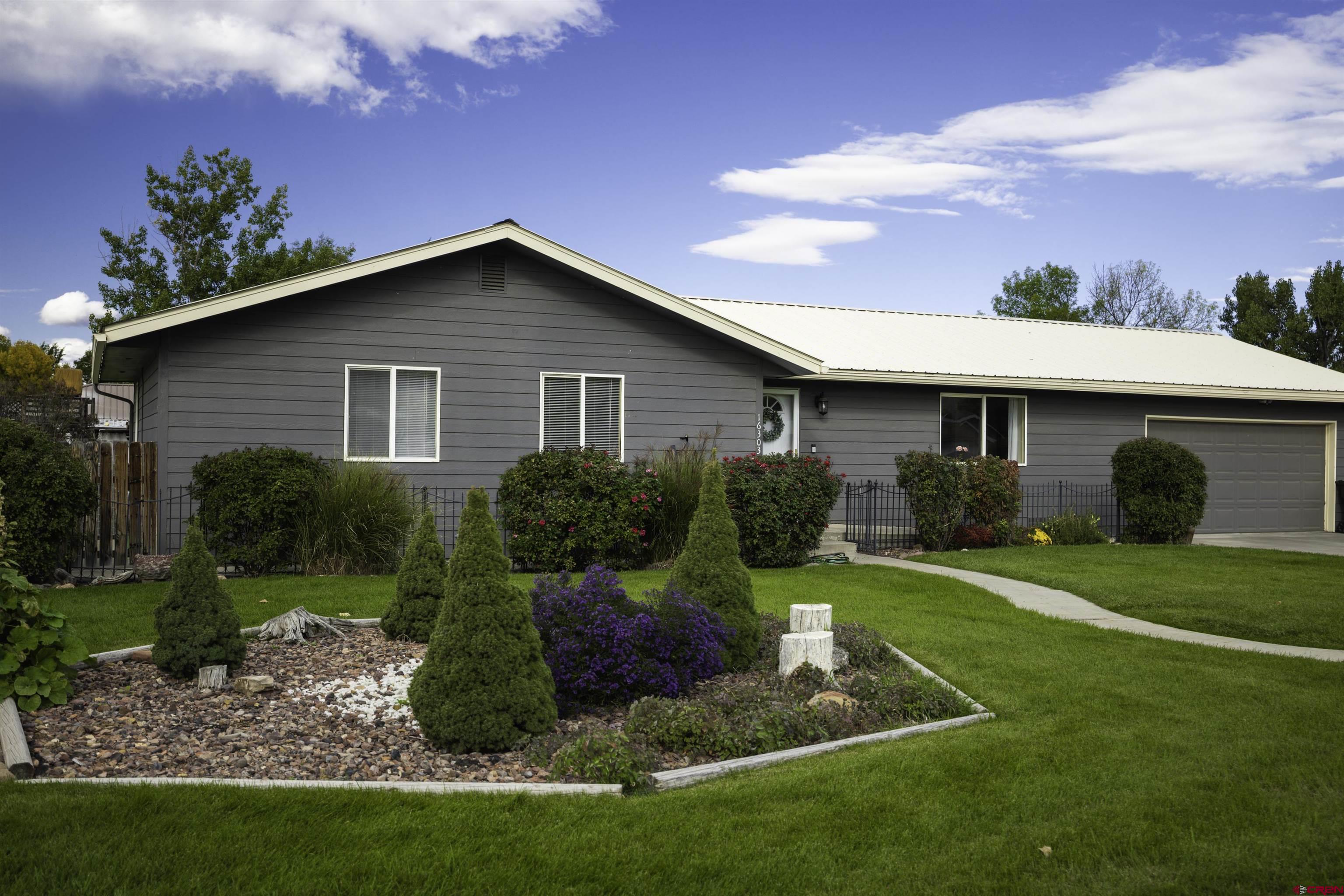 16303 6420th Road Montrose, CO 81403 - Photo 22 of 31 a view of a house with a yard and potted plants