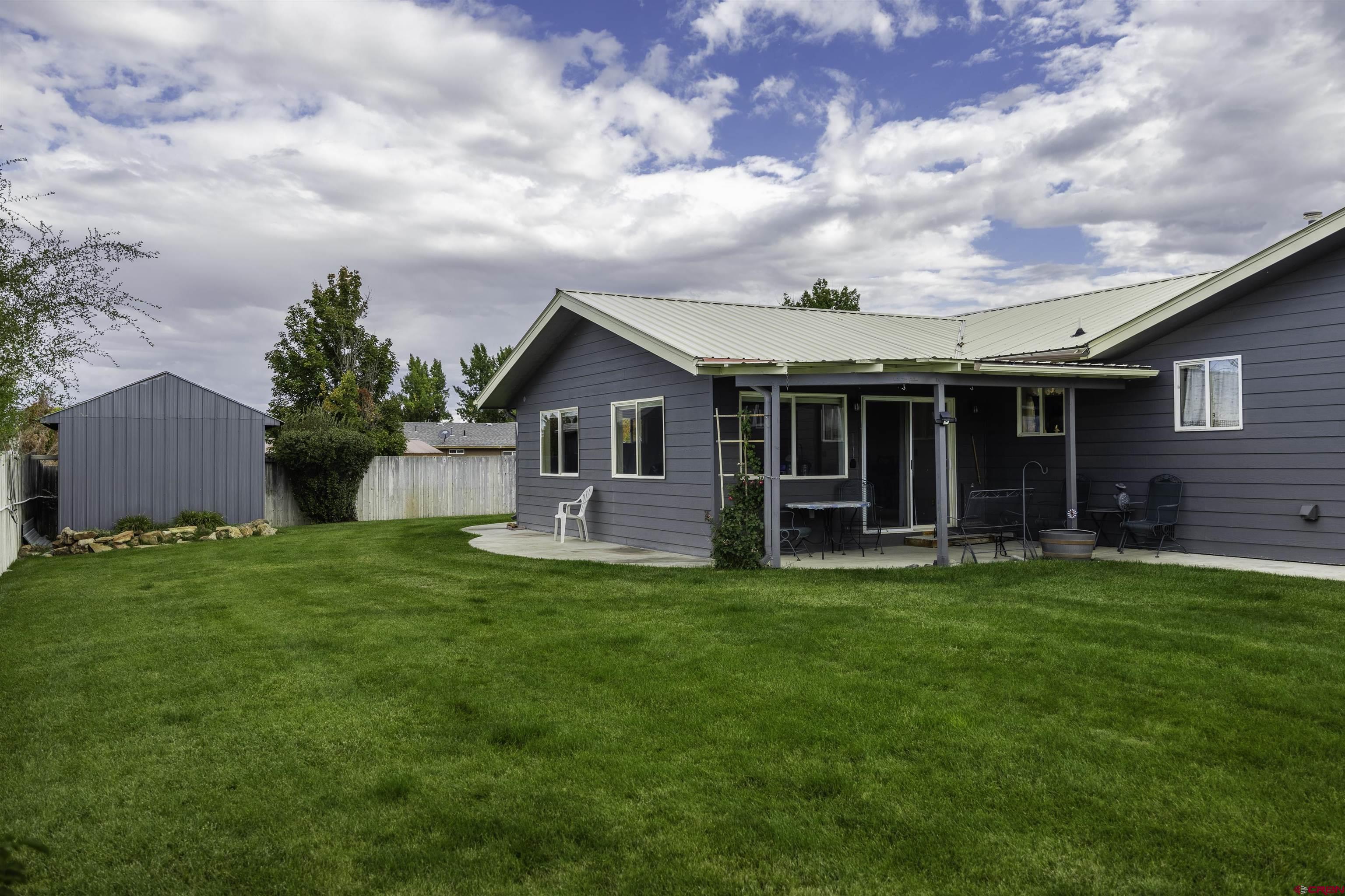 16303 6420th Road Montrose, CO 81403 - Photo 25 of 31 a view of a house with a yard and sitting area
