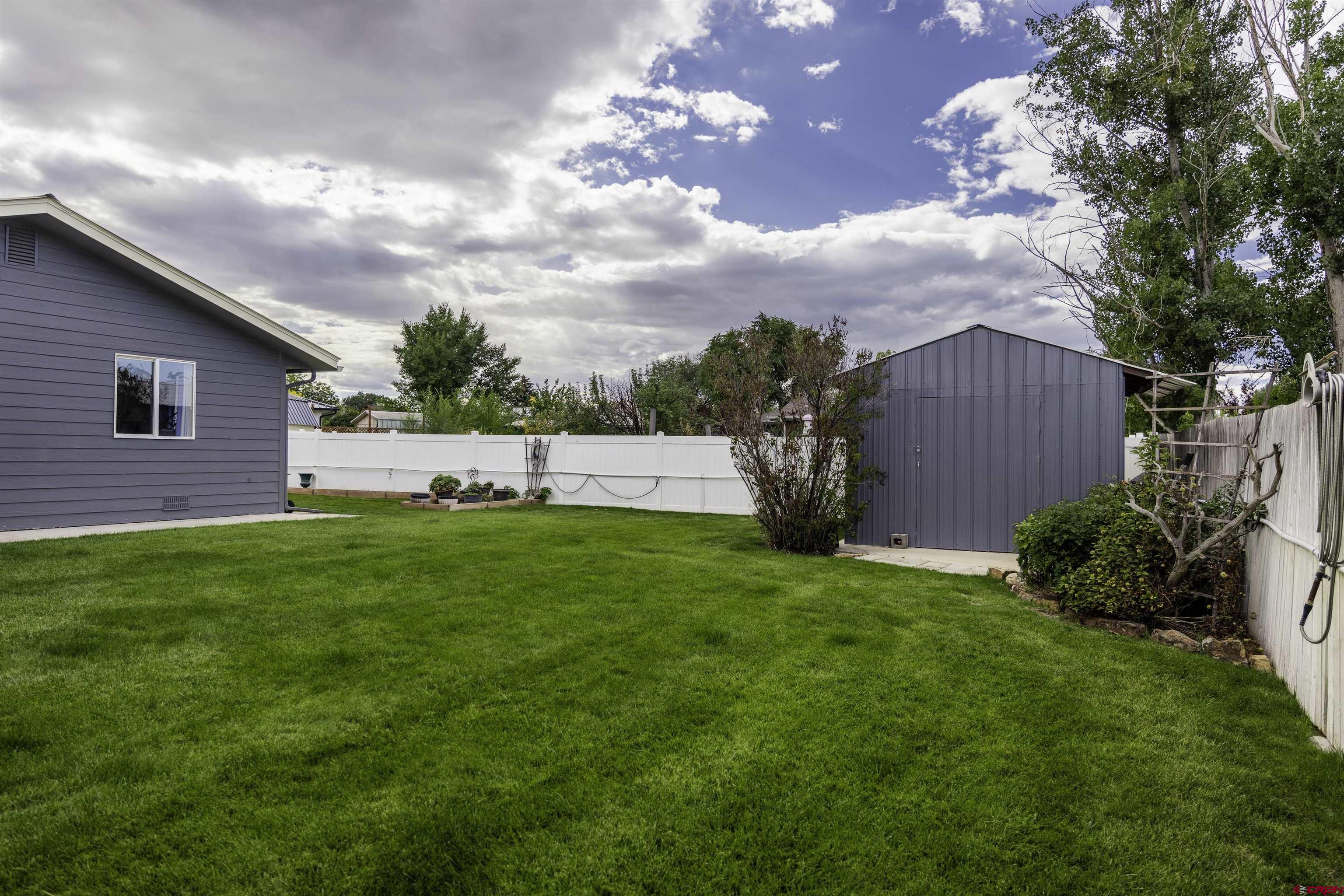 16303 6420th Road Montrose, CO 81403 - Photo 28 of 31 a view of yard with grass and a plants