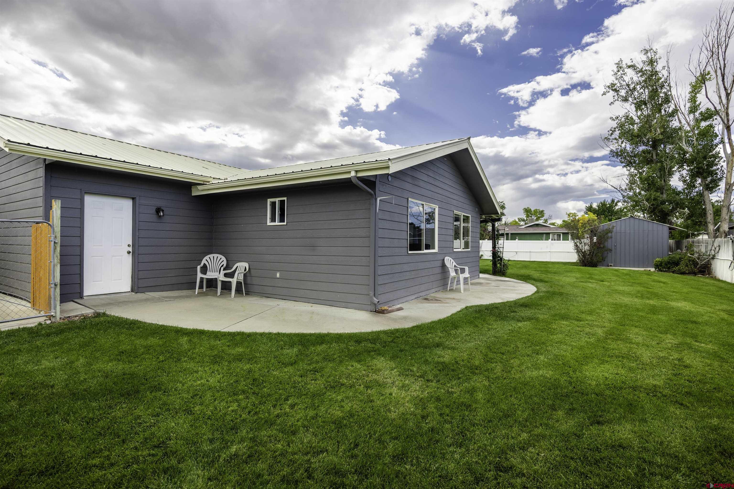 16303 6420th Road Montrose, CO 81403 - Photo 30 of 31 a front view of a house with garden and trees