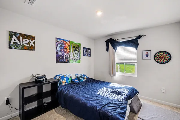 a bedroom with a bed and a window