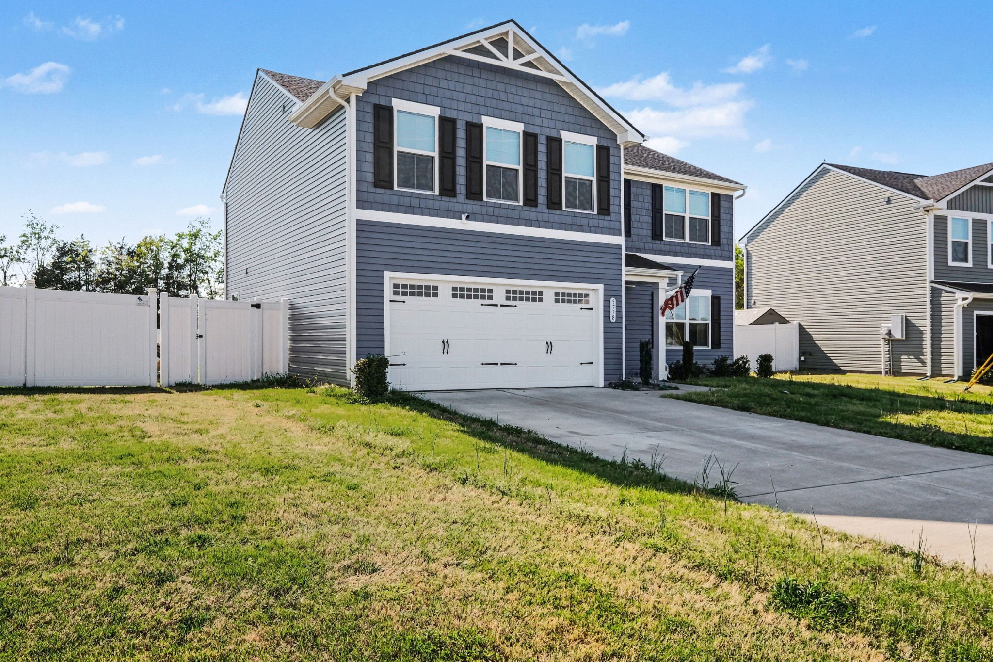 5778 Stardive Way Christiana, TN 37037 - Photo 2 of 29 a front view of a house with a yard and garage