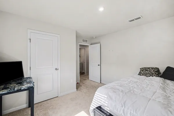 a bedroom with a bed and a flat screen tv
