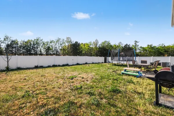 view of outdoor space with swimming pool and trees in the background
