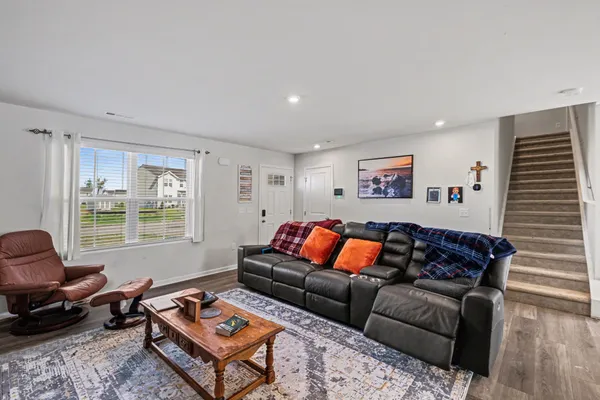 a living room with furniture a rug and a window