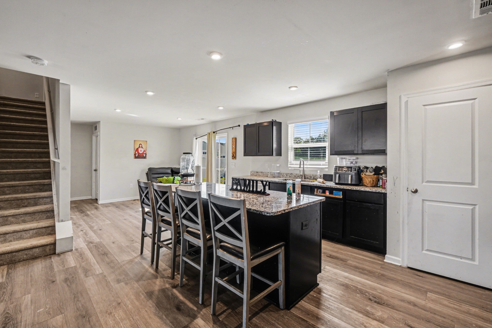 5778 Stardive Way Christiana, TN 37037 - Photo 8 of 29 a dining hall with stainless steel appliances granite countertop a stove and a refrigerator