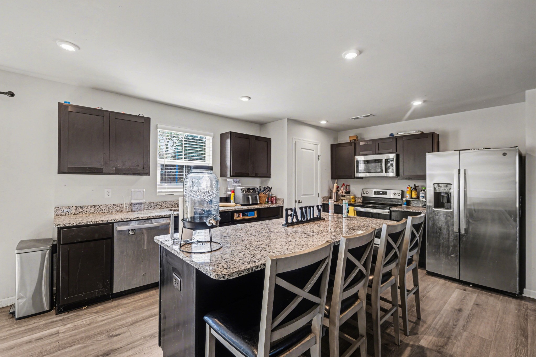 5778 Stardive Way Christiana, TN 37037 - Photo 9 of 29 a kitchen with kitchen island a dining table chairs stainless steel appliances and cabinets