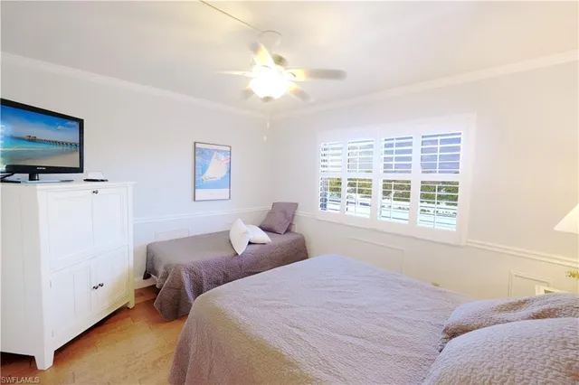 a bedroom with two beds and a window