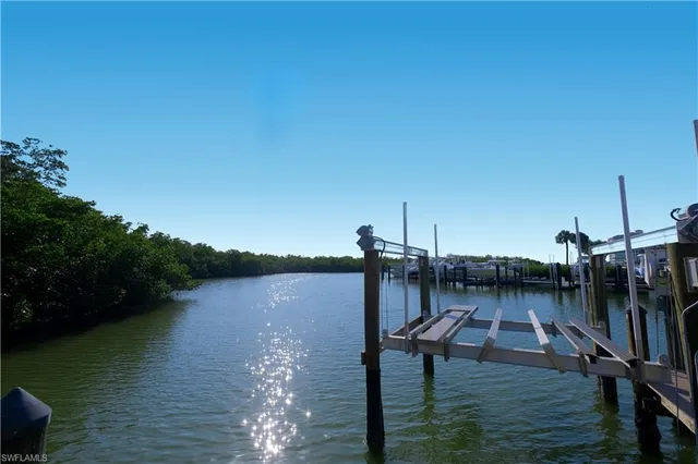 a view of a lake with boats and a bridge