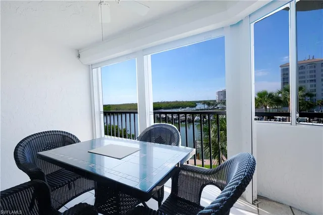 a view of a balcony dining table and chairs