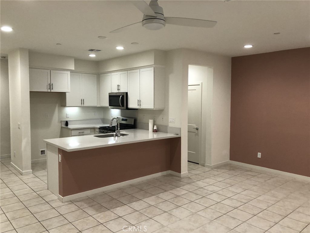 211 Red Brick Drive, Unit 3 Simi Valley, CA 93065 - Photo 5 of 13 a kitchen with stainless steel appliances granite countertop a stove a sink and a refrigerator