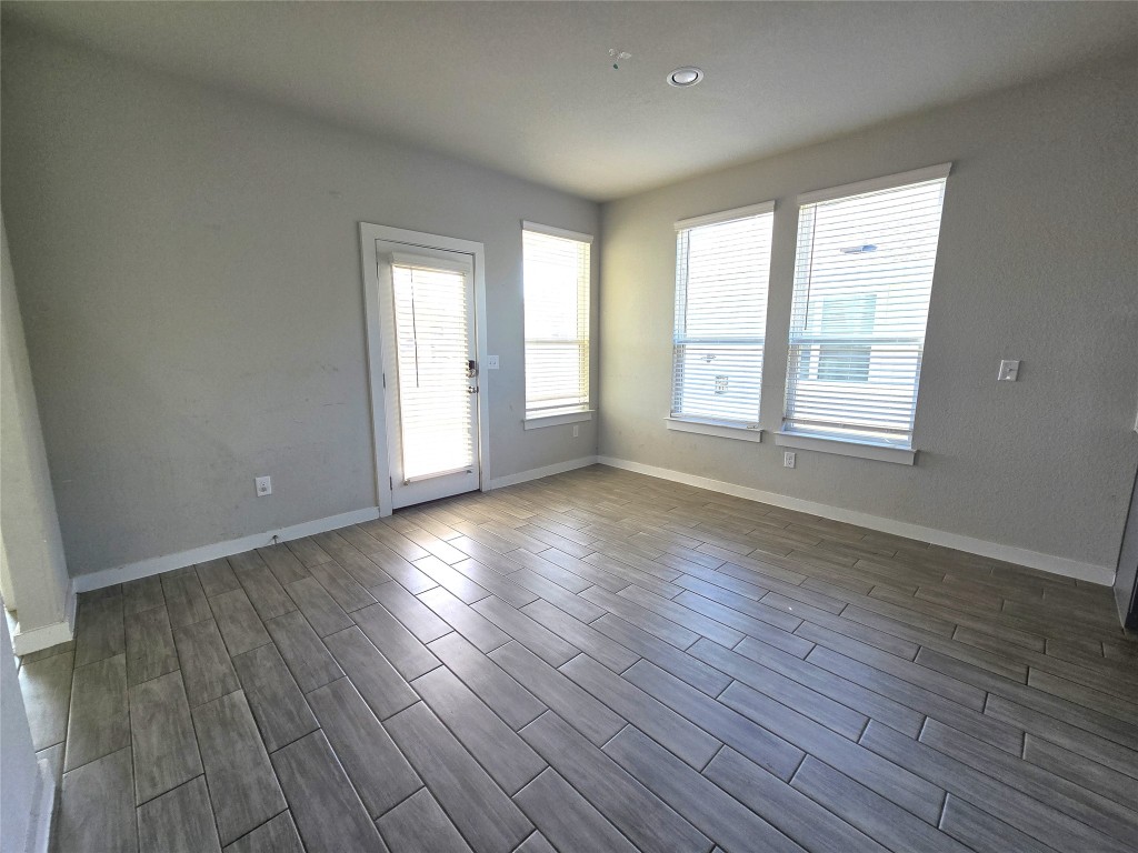 141 Appleberry Lane Elgin, TX 78621 - Photo 5 of 17 an empty room with wooden floor and windows