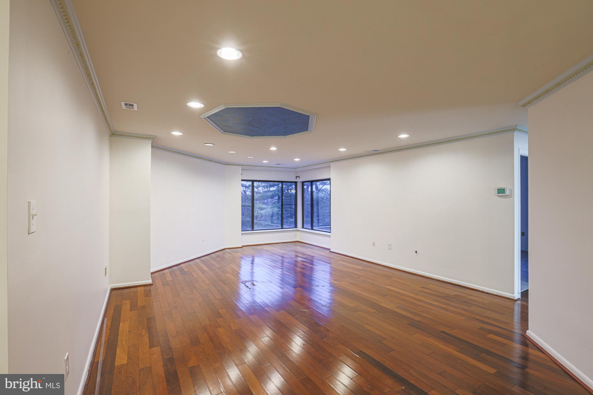 3041 Fallstaff Road, Unit 405D Baltimore, MD 21209 - Photo 17 of 38 an empty room with wooden floor and windows