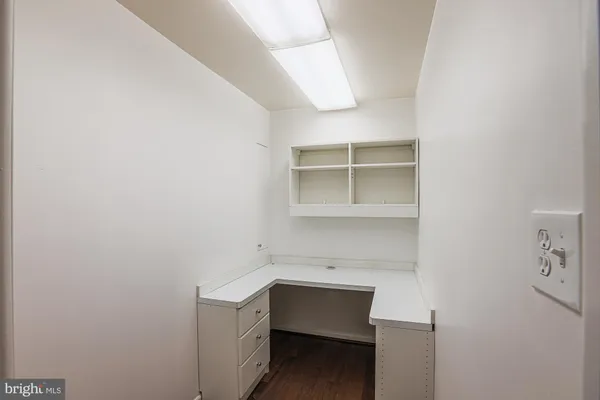 a room with a bench and cabinets
