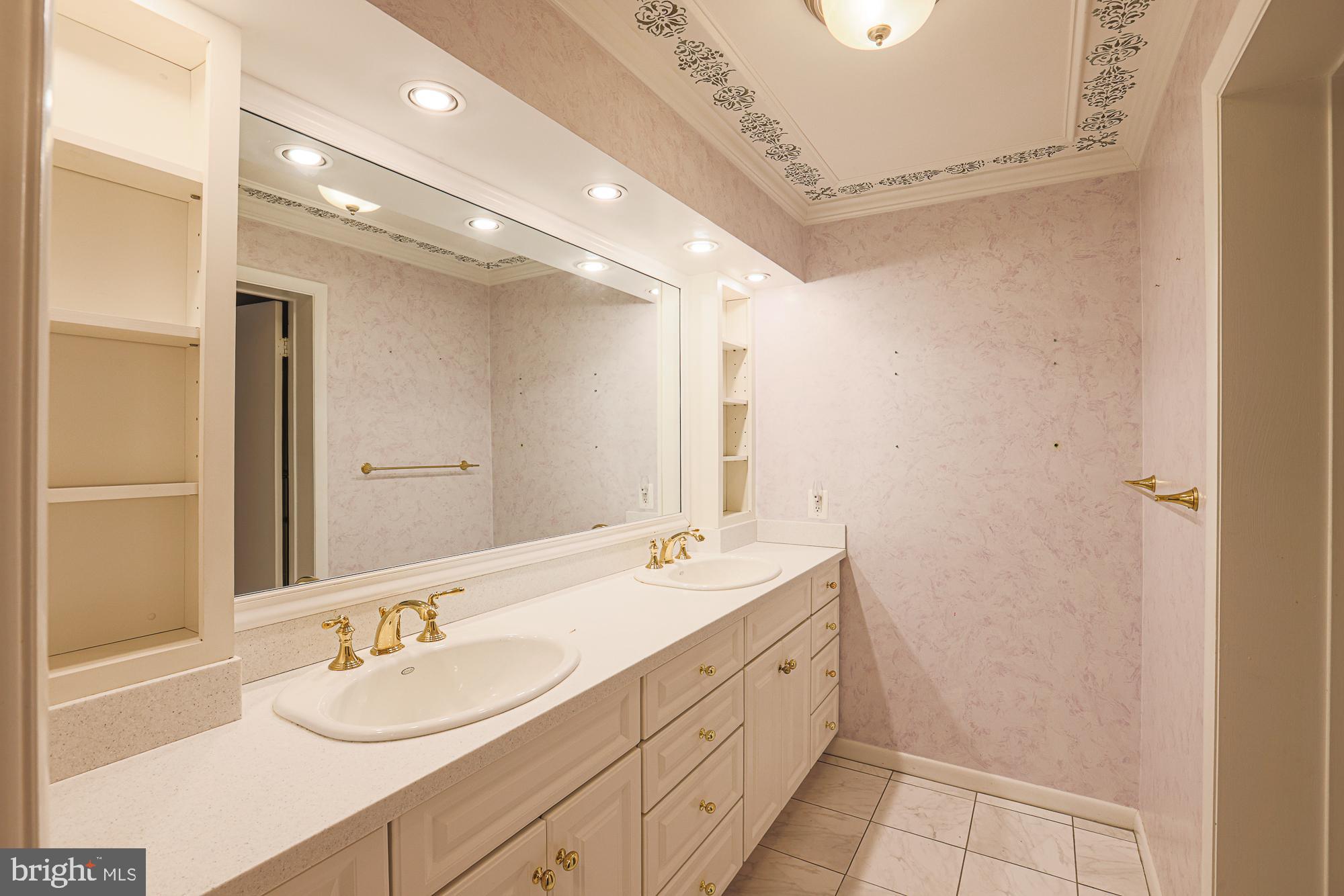 3041 Fallstaff Road, Unit 405D Baltimore, MD 21209 - Photo 28 of 38 a bathroom with a double vanity sink and a mirror
