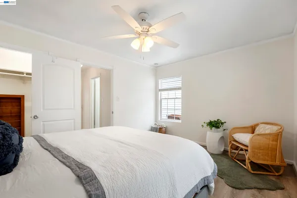 a bedroom with a bed and chair
