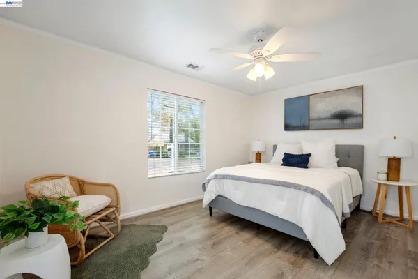 a spacious bedroom with a bed and a chandelier