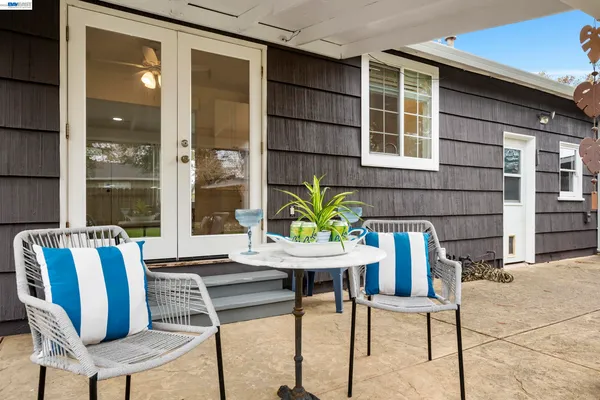 a view of a patio with table and chairs and potted plants