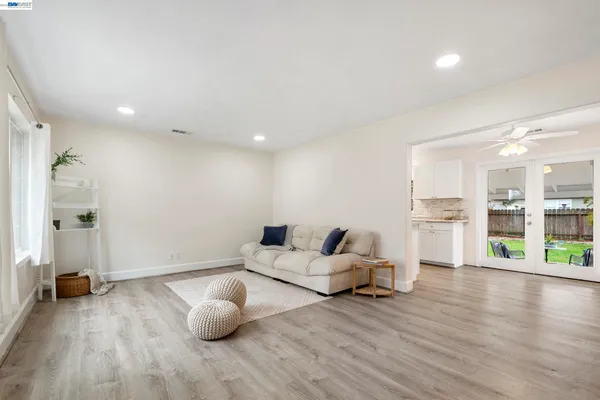 a living room with furniture and wooden floor