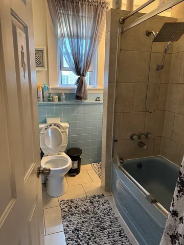 a bathroom with a sink a toilet and a shower