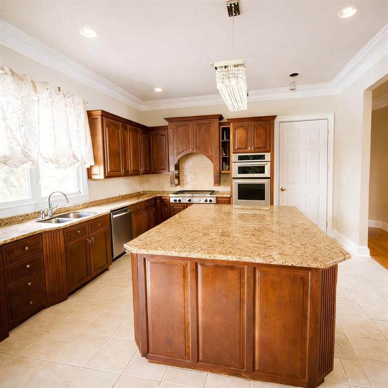 3930 Demooney Road Atlanta, GA 30349 - Photo 15 of 36 a kitchen with kitchen island granite countertop a sink stainless steel appliances and cabinets