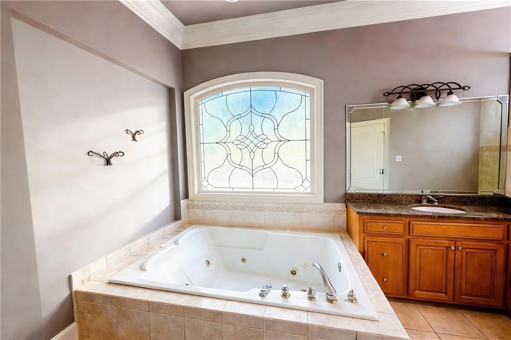 3930 Demooney Road Atlanta, GA 30349 - Photo 18 of 36 a bath tub sitting in a bathroom next to a window