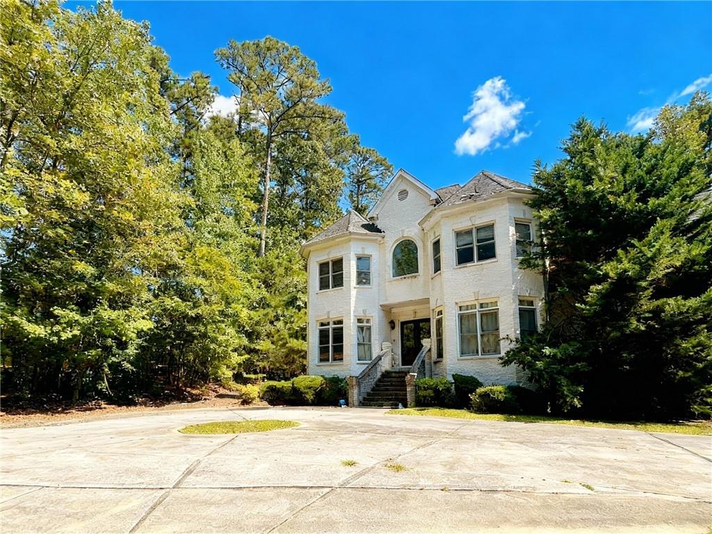 3930 Demooney Road Atlanta, GA 30349 - Photo 3 of 36 a front view of a house with a yard
