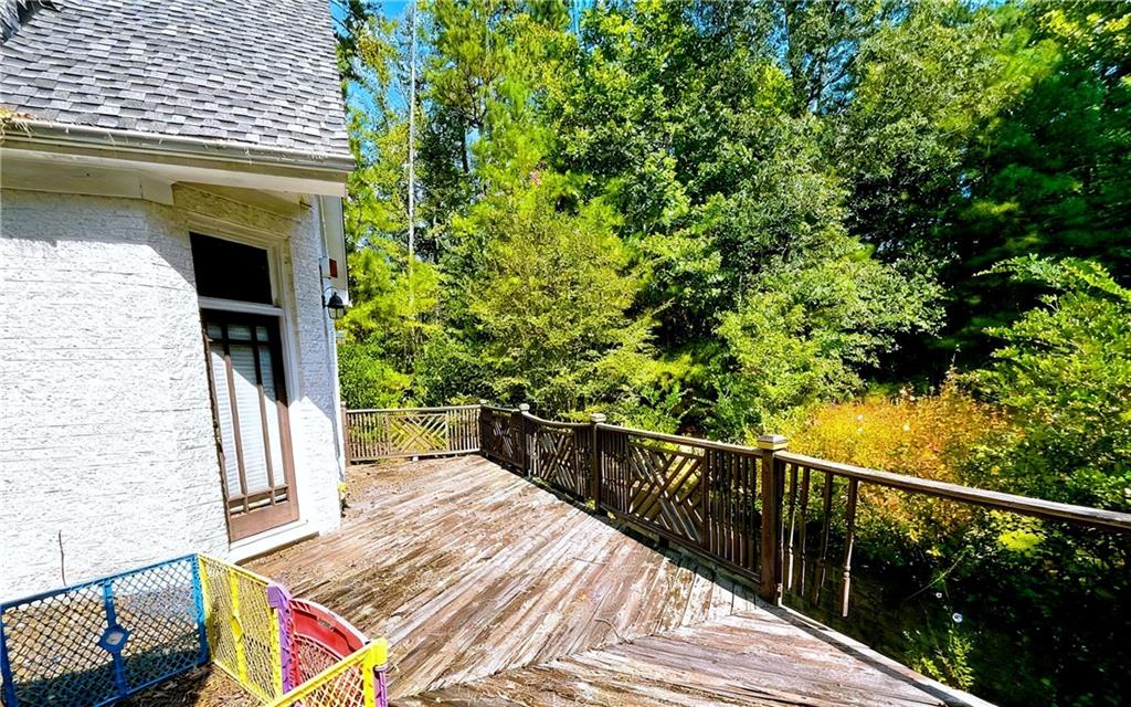 3930 Demooney Road Atlanta, GA 30349 - Photo 33 of 36 a view of balcony with wooden floor and fence