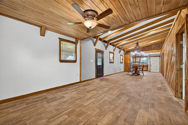 a view of a livingroom with wooden floor and furniture