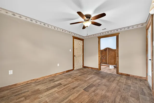 a view of a livingroom with a ceiling fan and window