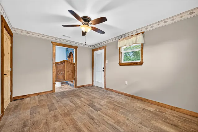 a view of a livingroom with a ceiling fan and window